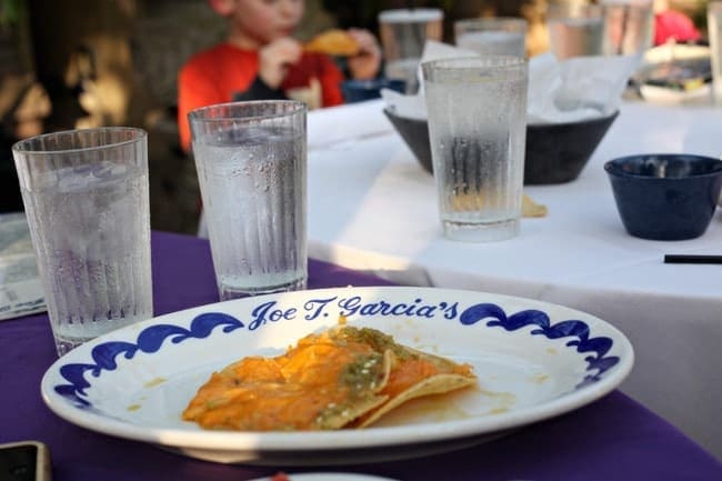 Plate of food in front of glasses of water at a restaurant 