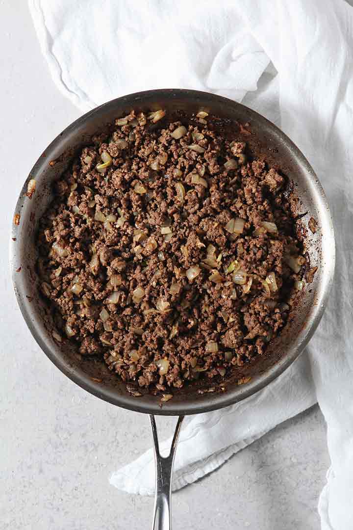 Cooked beef is shown in a skillet before deglazing