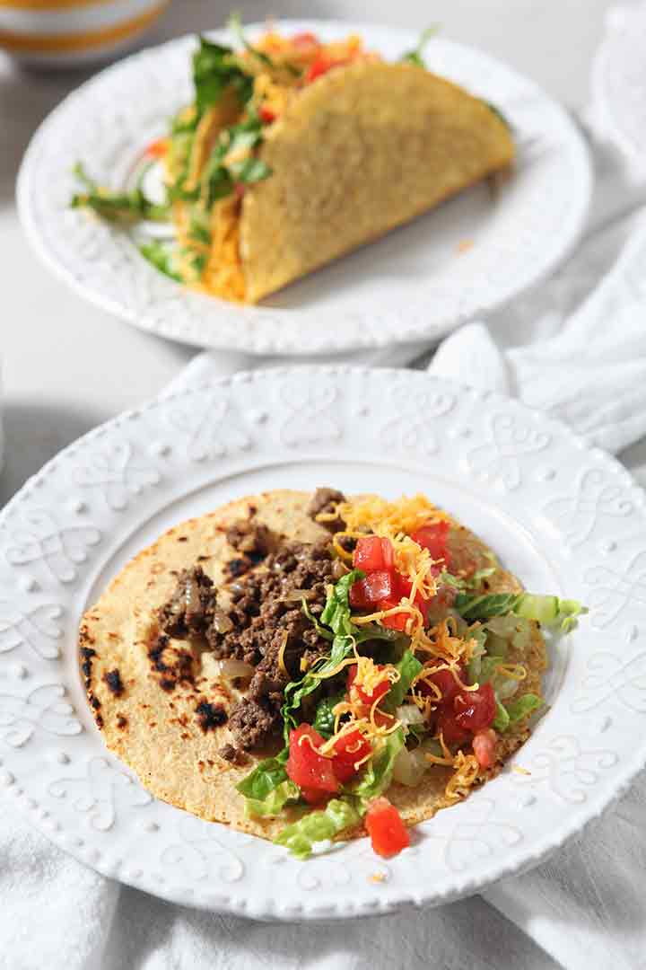 A soft tortilla holds ground beef and other taco toppings, before consuming