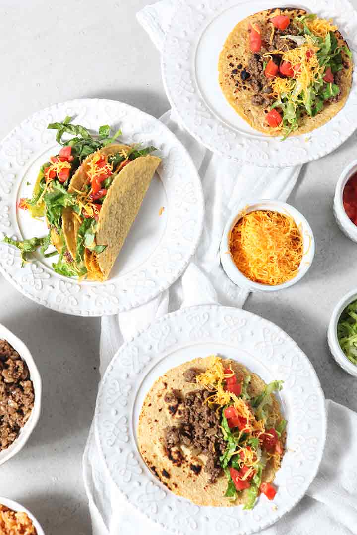 Overhead image of several Ground Beef Tacos on plates