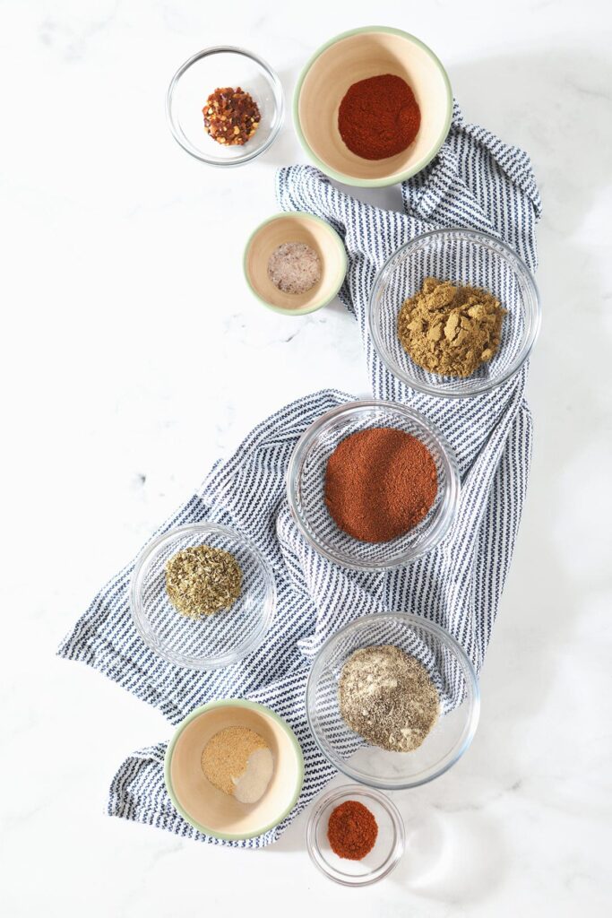 Spices for a homemade spice blend on a blue towel