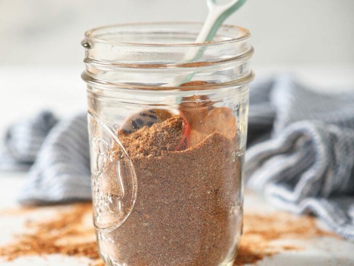 A jar of DIY taco seasoning on marble