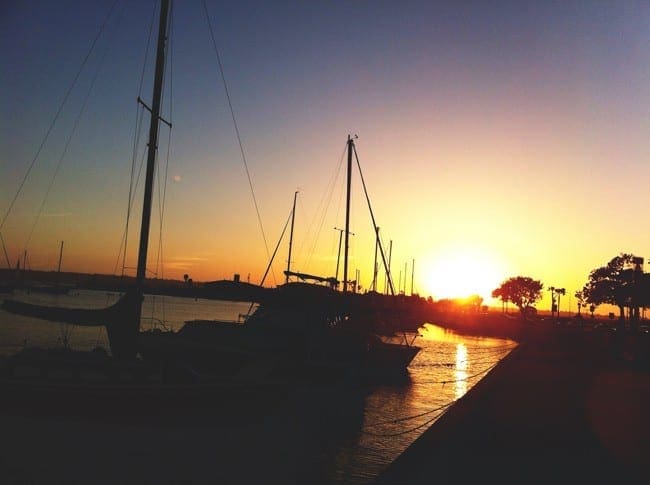 Boats in silhouette at sunset in San Diego