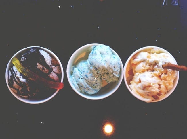 Three ice cream bowls on a black surface