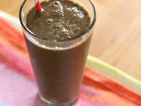 Overhead image of a Spinach Strawberry Breakfast Smoothie on a colorful kitchen towel