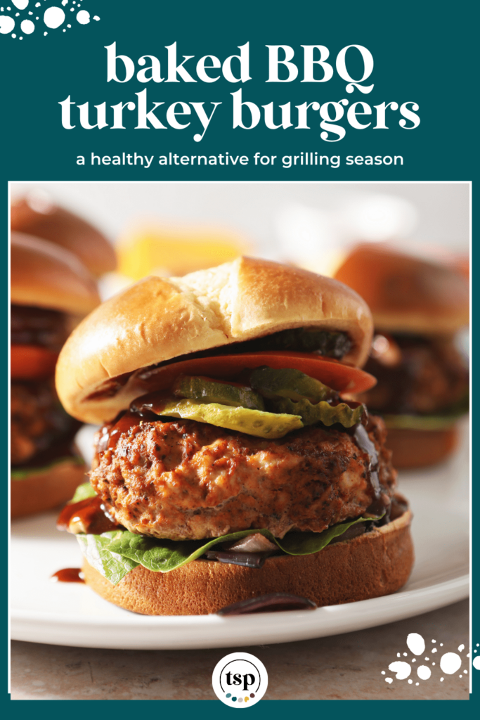 A BBQ Baked Turkey Burger on a white plate with other burgers in the background with the text baked BBQ turkey burgers a healthy alternative for grilling season