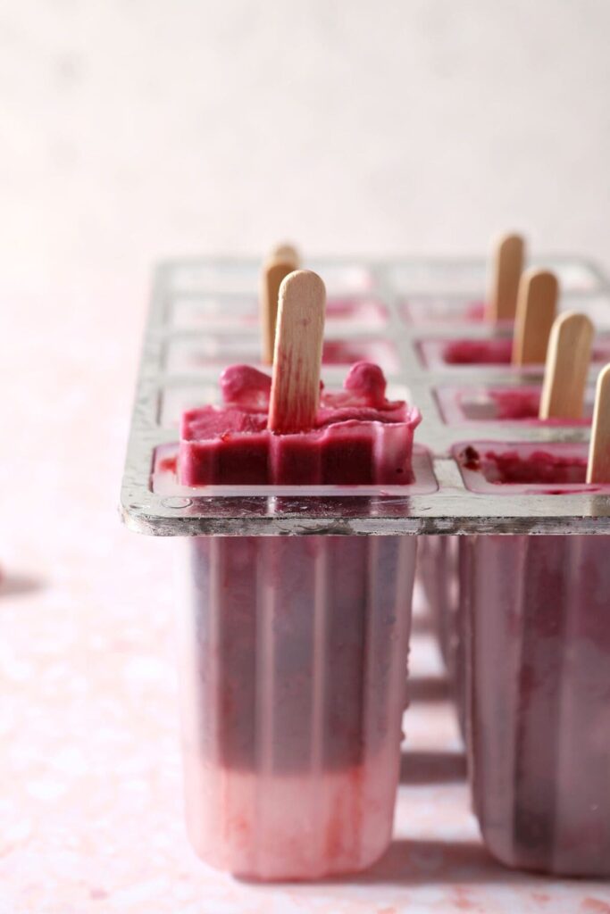 Frozen berry yogurt pops in a mold