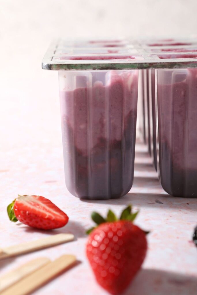 Berry yogurt pops in molds, from the side