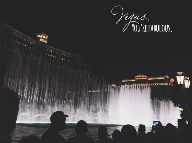 Fountains in front of the Bellagio in Vegas at night with people silhouetted in front of it with text saying, "Vegas, you're fabulous"