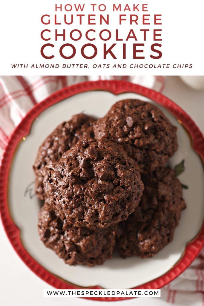 Close up of Chocolate Almond Butter Cookies with Chocolate Chips on a red-rimmed plate sitting on a red plaid towel with the text 'how to make gluten free chocolate cookies with almond butter, oats and chocolate chips'