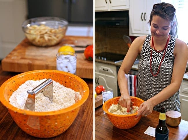 A woman mixing ingredients in an orange bowl 