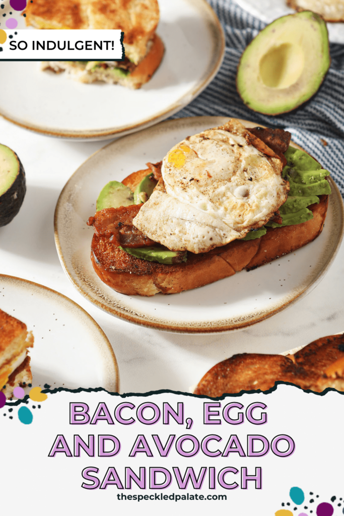 Open-faced breakfast sandwiches on small plates with egg, bacon and avocado with the text bacon, egg and avocado sandwich