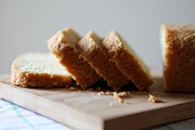 Close up of sliced pound cake on wood cutting board 