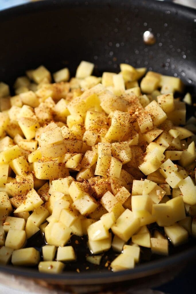 Diced gold potatoes in a skillet