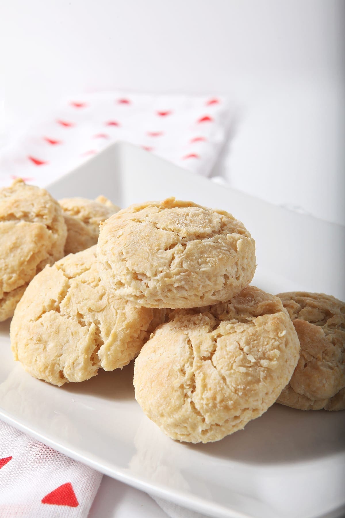 A plate of vegan biscuits on top of a red patterned towel