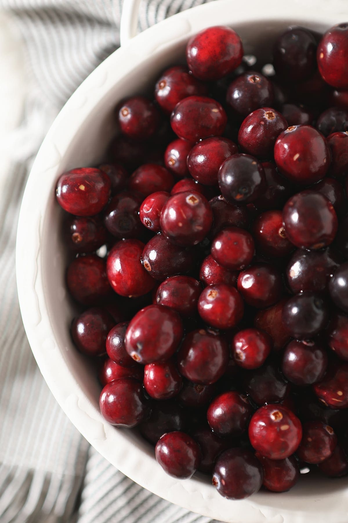 Close up of cranberries in a white colander