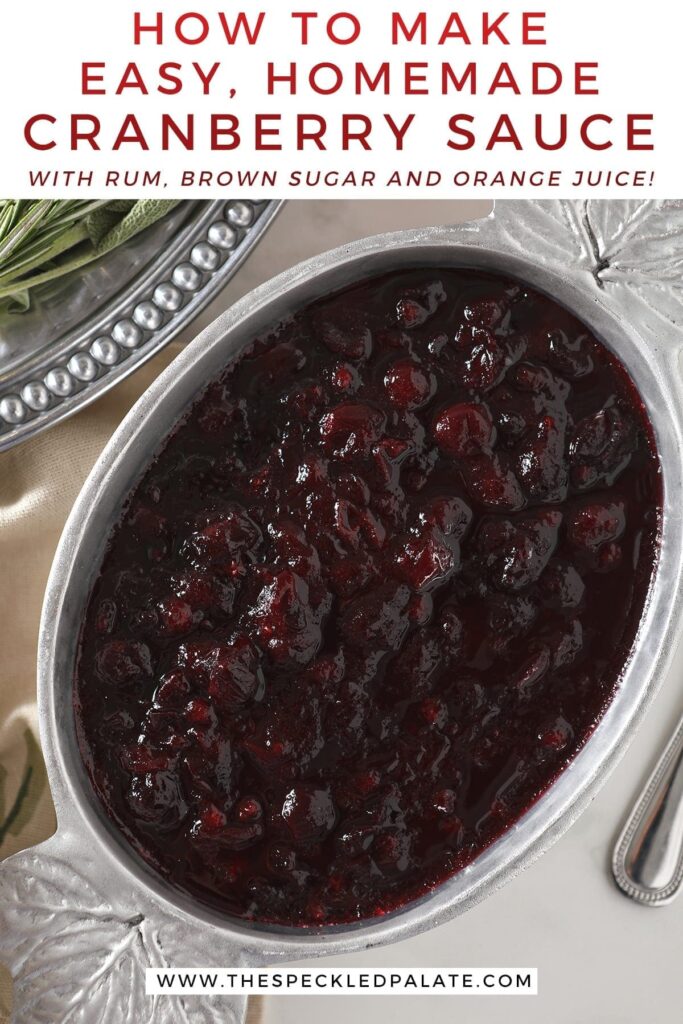 Close up of chilled spiced cranberry sauce in a silver serving bowl with maple leafs on the corners with the text 'how to make easy, homemade cranberry sauce with rum, brown sugar and orange juice'