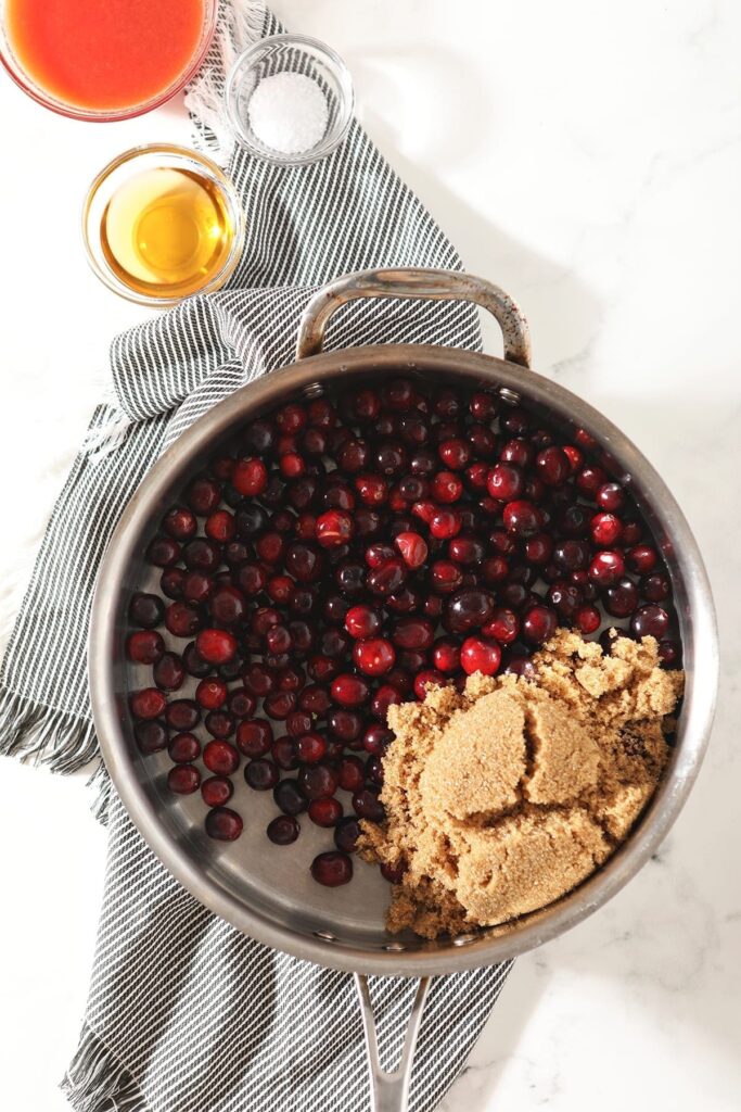 cranberries and sugar in a metal pot