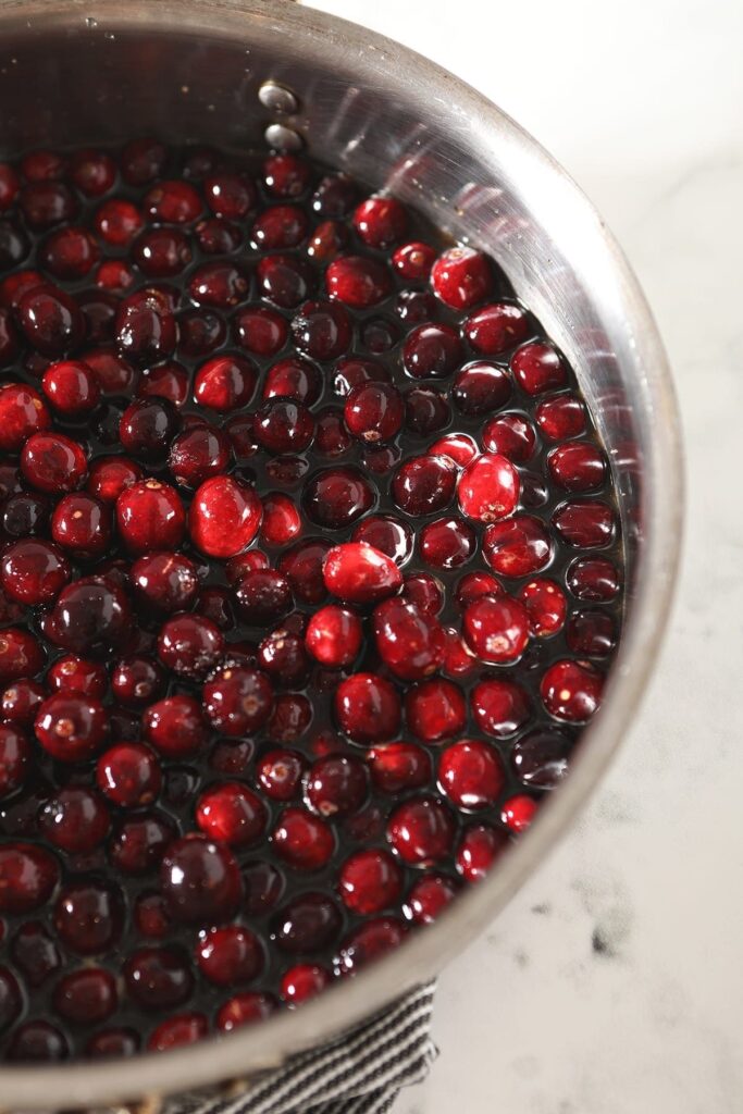 Cranberries cook down in a skillet