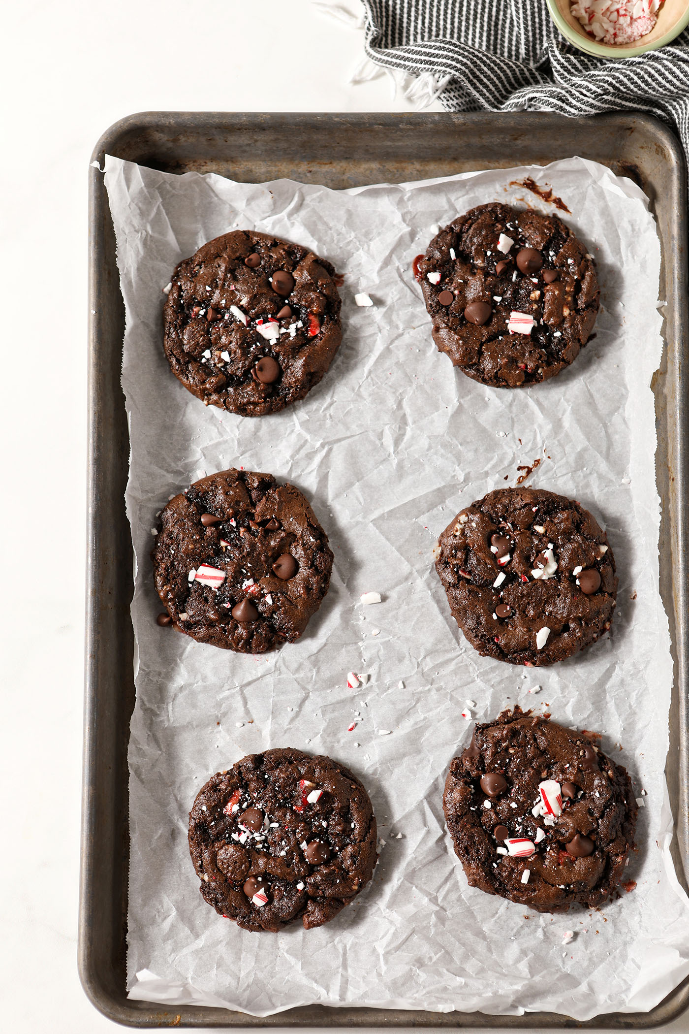 Baked Chocolate Peppermint Chocolate Chip Cookies on a parchment-lined sheet pan