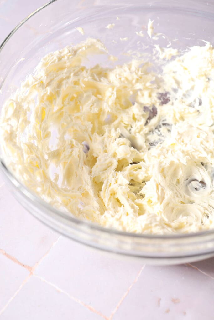 creamed butter and cream cheese in a bowl on a purple surface