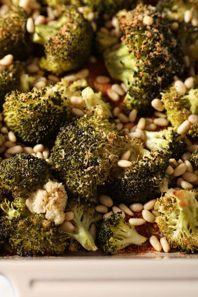 Close up of Roasted Parmesan Broccoli with Pine Nuts in a serving dish