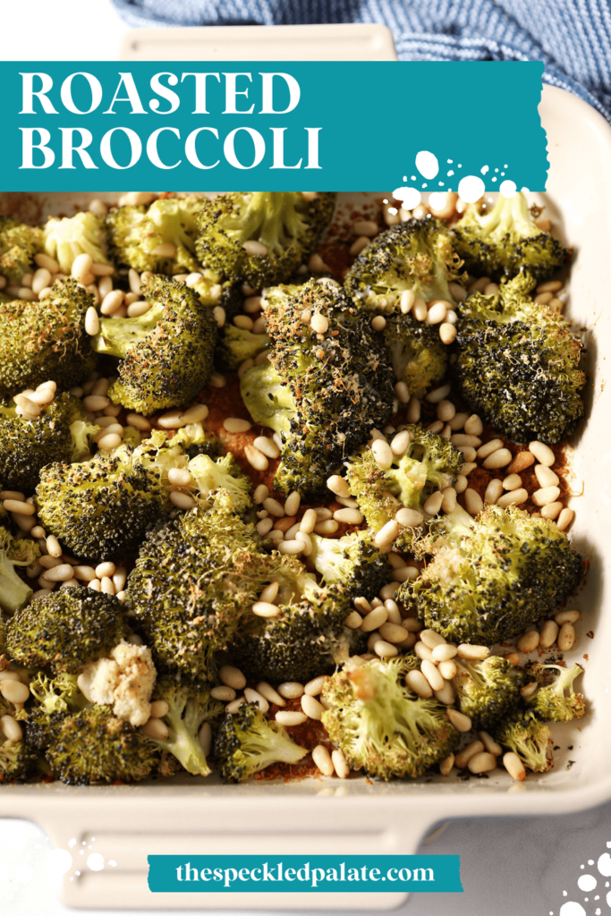 Close up of cooked broccoli with with parmesan and pine nuts in a serving dish with the text Roasted Broccoli