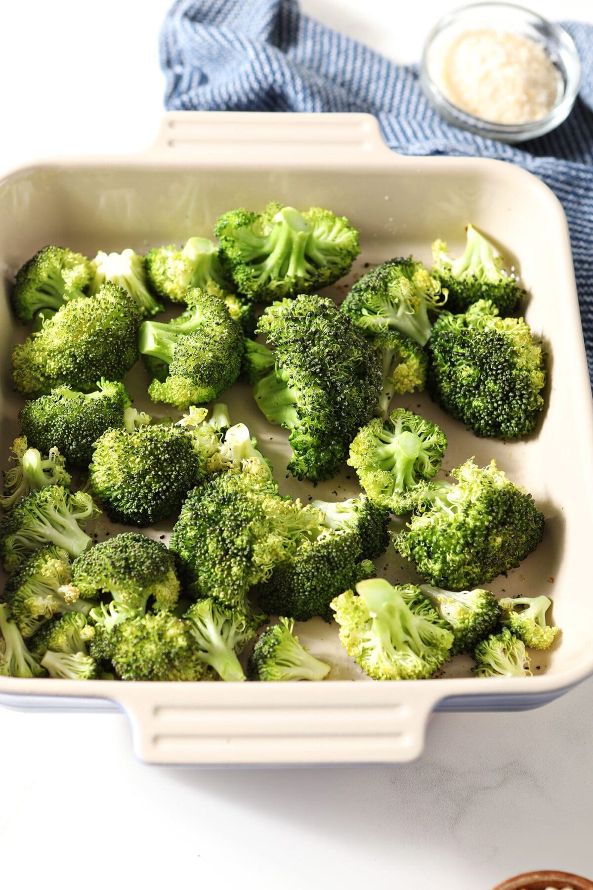 Broccoli tossed with oil in a casserole dish