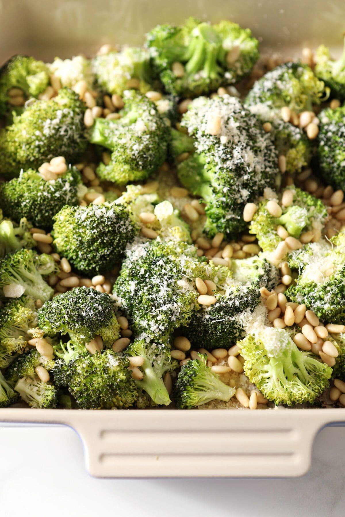 Roasted Parmesan Broccoli with Pine Nuts in a casserole dish before roasting