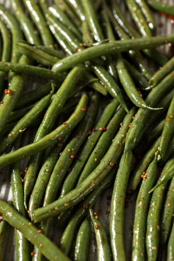 Green beans on a sheet pan, before roasting