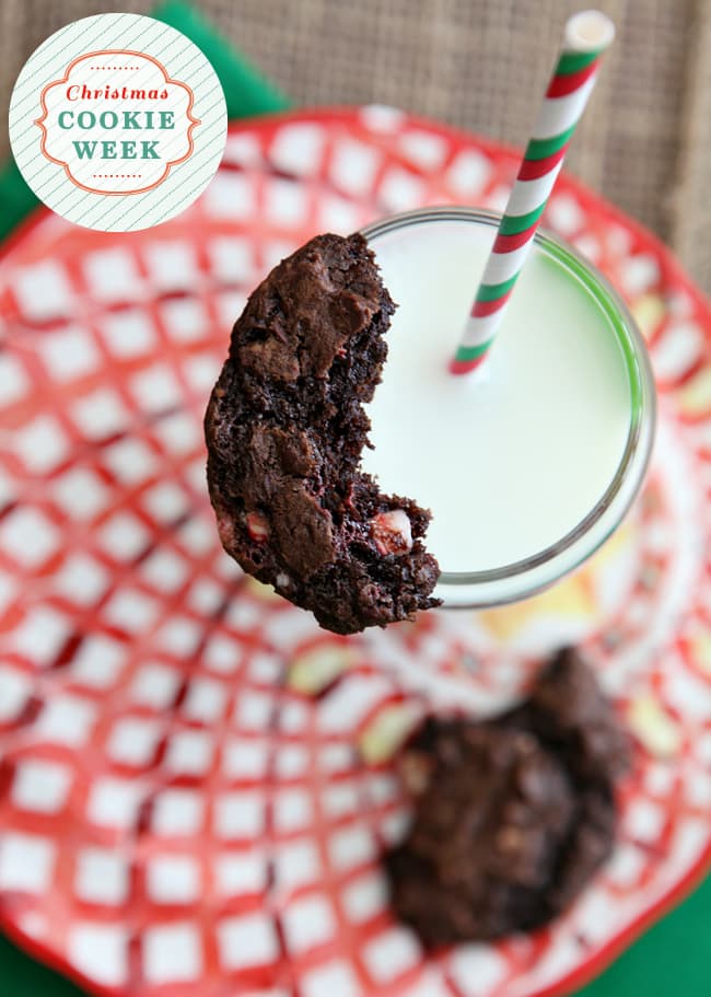 A half-eaten Peppermint Dark Chocolate Cookies sits on top of a glass of milk