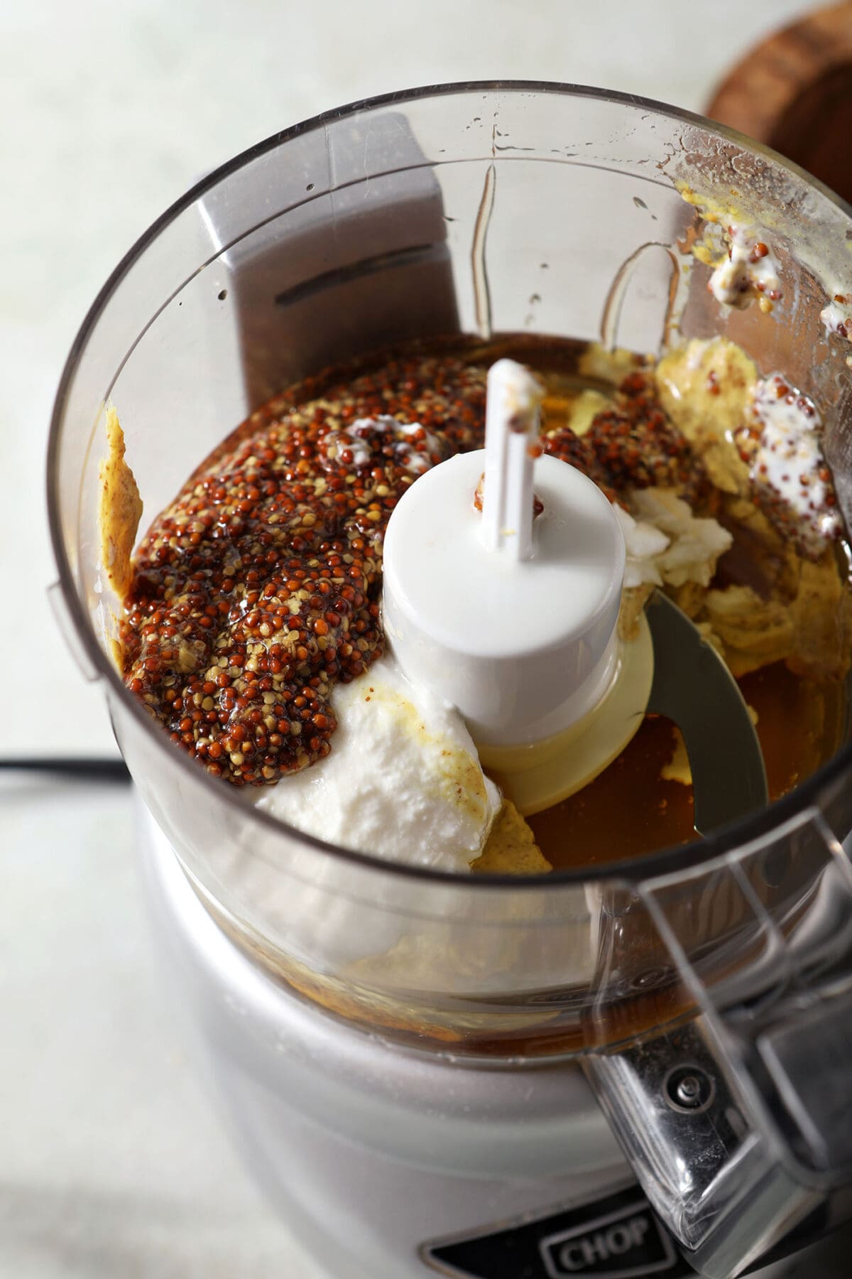 Ingredients to make honey mustard dressing in a food processor before blending