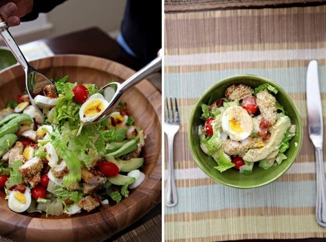 Overhead view of salad in a bowl with utensils 