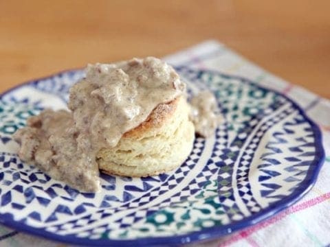 Southern-Style Biscuits and Gravy are the ULTIMATE Southern comfort breakfast! Fluffy, buttery biscuits are topped with a creamy white sausage gravy and make a perfect weekend meal.