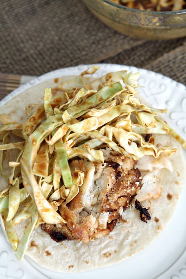 Close up of soy seared cod taco with spicy slaw on a plate 