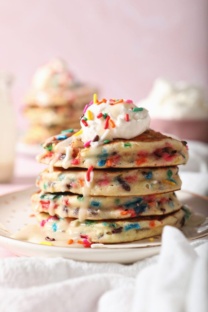 A stack of Funfetti Pancakes on a white plate