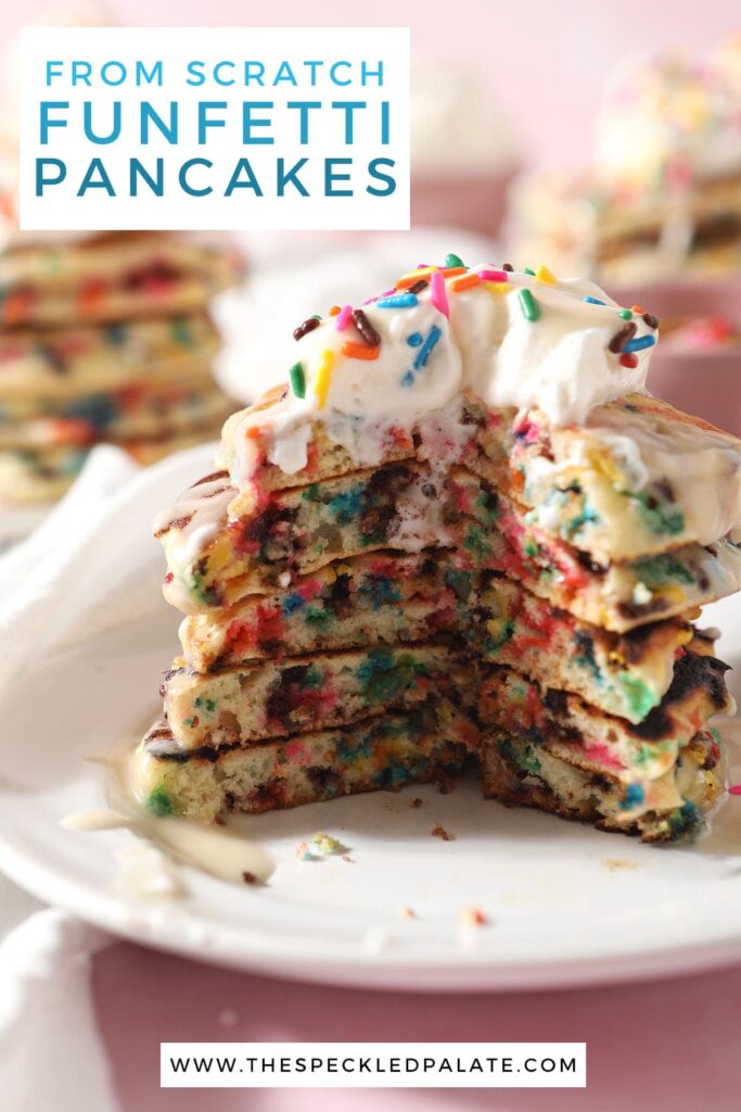 A cut-into stack of rainbow sprinkle pancakes on a white plate with the text from scratch funfetti pancakes