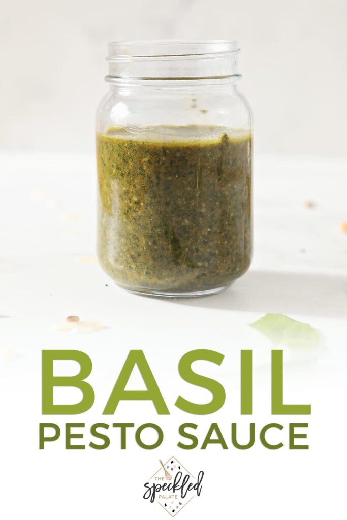 A jar of homemade pesto on marble with the text basil pesto sauce