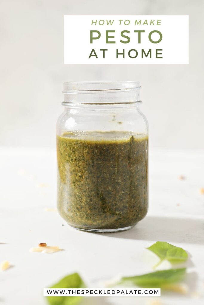 A jar of homemade pesto on marble with the text how to make pesto at home