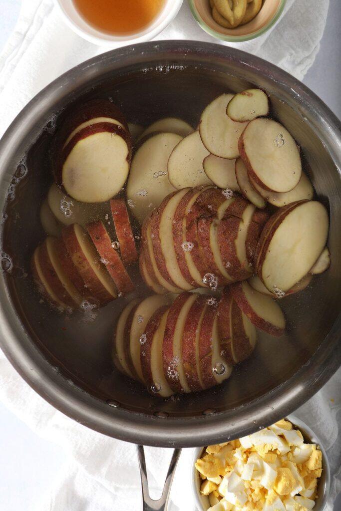 Red potatoes in a pot full of water