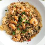 Close up of Cajun shrimp and grits recipe in a white bowl