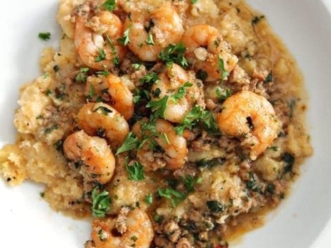 Close up of Cajun shrimp and grits recipe in a white bowl