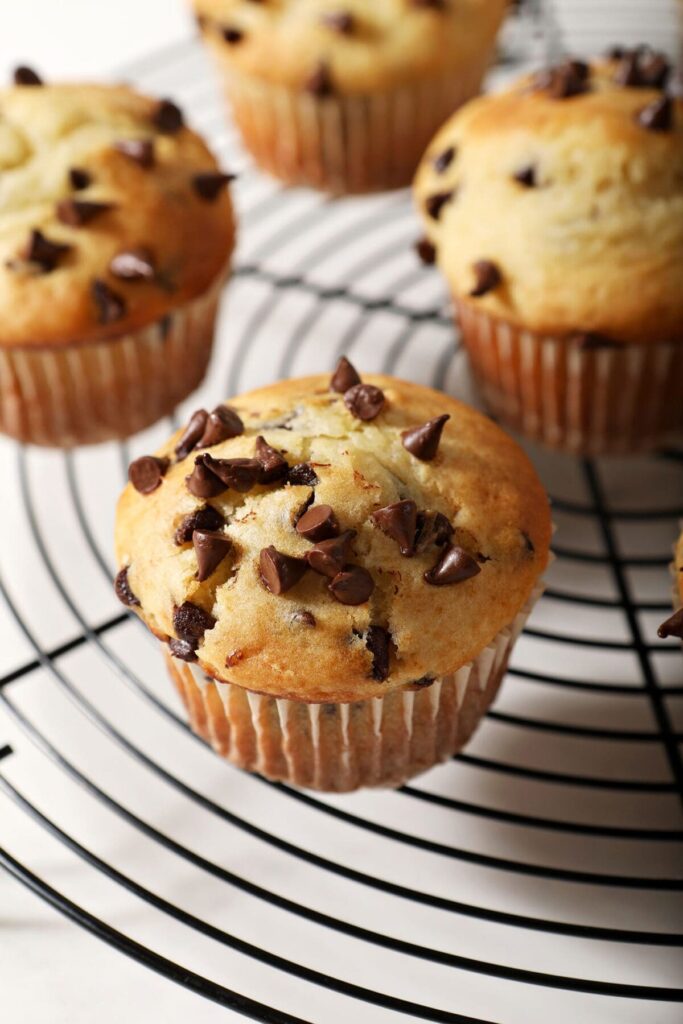 Chocolate Chip Muffins cool on a round cooling rack