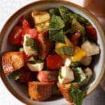 close up of a bowl of panzanella salad with caprese flavors