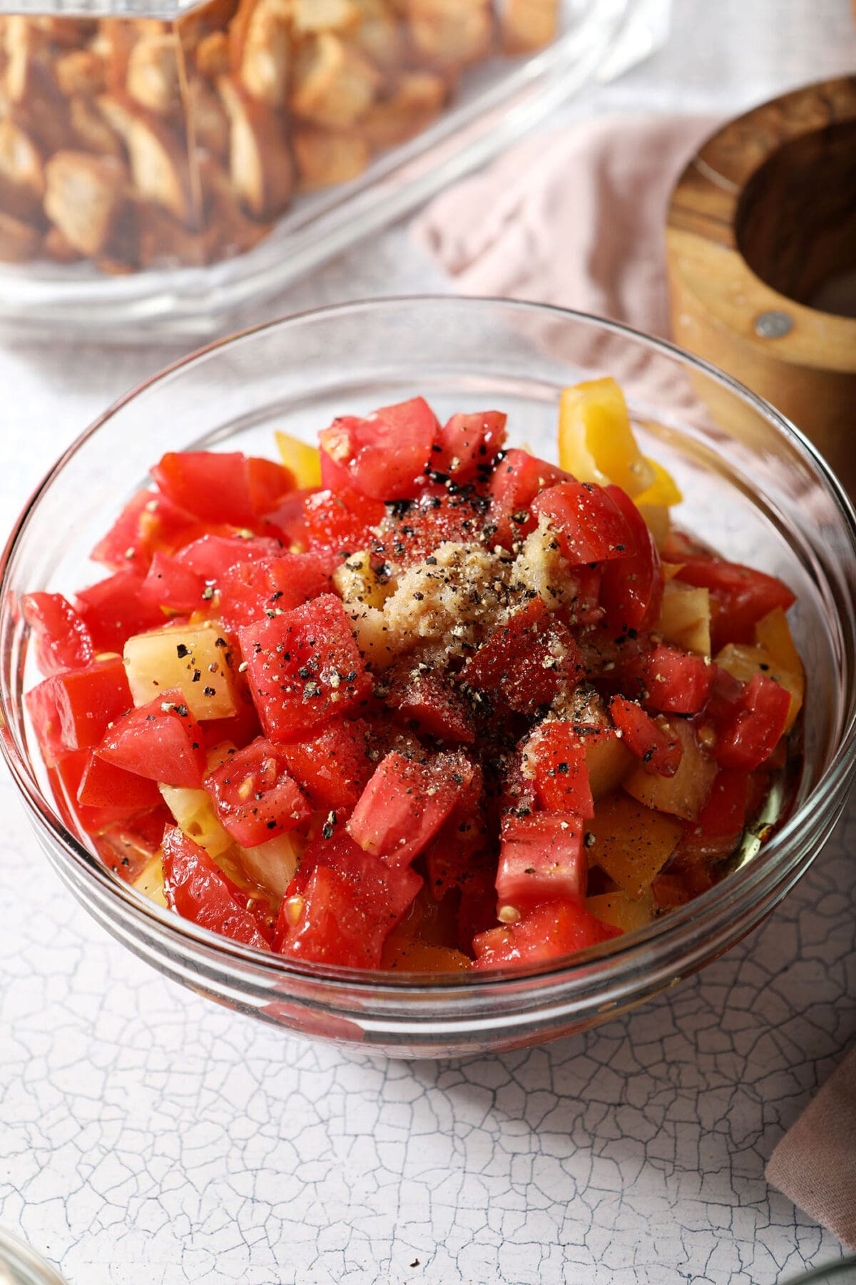 fresh tomatoes with other dressing ingredients marinating in a bowl