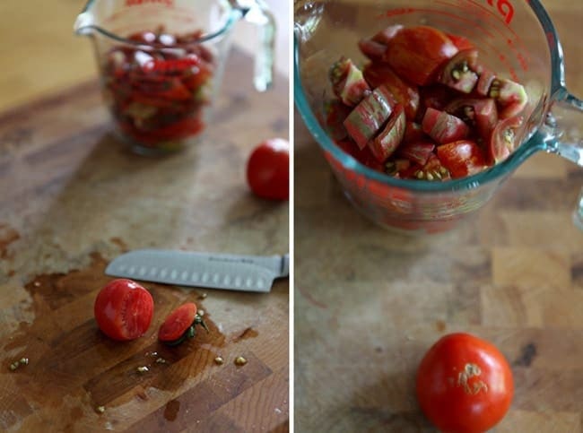 Bowl of tomatoes being sliced on wood cutting board with knife 