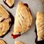 Strawberry and Blueberry Hand Pies, fresh from the oven, sit on their nonstick baking mat.