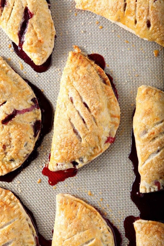 Close up of baked hand pies on a nonstick baking mat