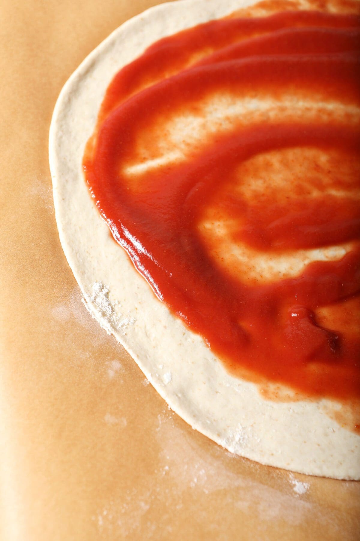 Close up of tomato sauce on pizza dough