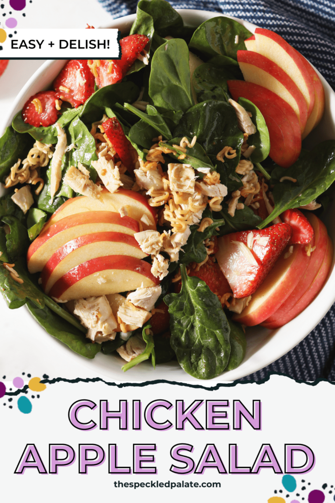 Apples, strawberries and chicken on a spinach salad with the text chicken apple salad